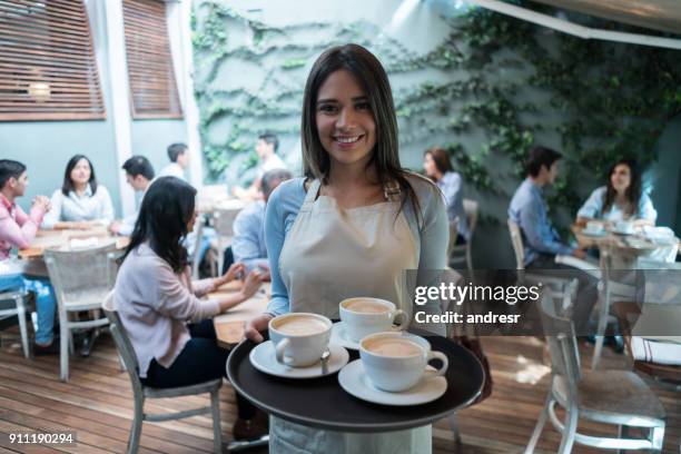 portrait of a waitress working at a cafe serving coffee - waitress stock pictures, royalty-free photos & images