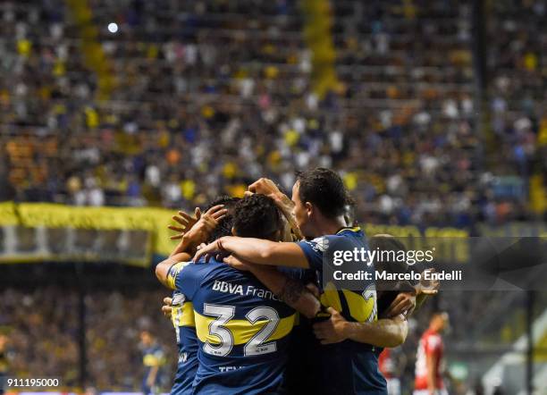 Cristian Pavon of Boca Juniors celebrates with teammates after scoring the first goal of his team during a match between Boca Juniors and Colon as...