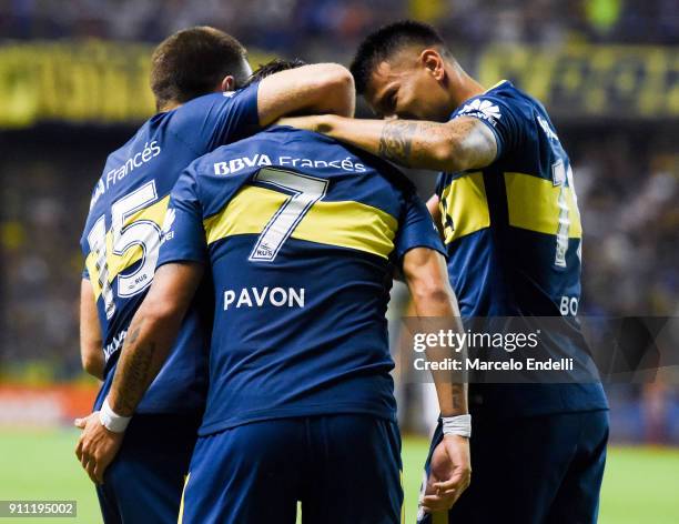 Cristian Pavon of Boca Juniors celebrates with teammates Nahitan Nandez and Walter Bou after scoring the first goal of his team during a match...