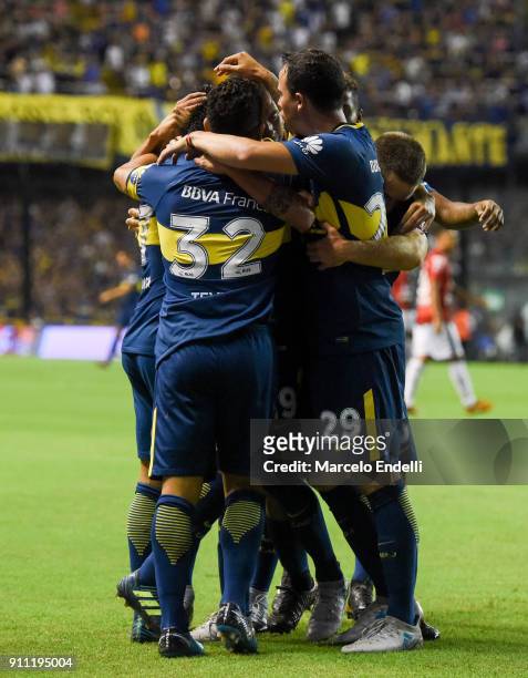 Cristian Pavon of Boca Juniors celebrates with teammates after scoring the first goal of his team during a match between Boca Juniors and Colon as...
