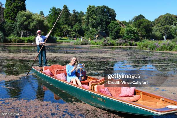 Caroline Wozniacki of Denmark poses with the Daphne Akhurst Memorial Cup on an elegant wooden punt ride at the Royal Botanic Gardens after winning...