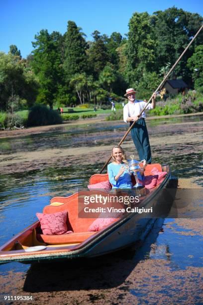 Caroline Wozniacki of Denmark poses with the Daphne Akhurst Memorial Cup on an elegant wooden punt ride at the Royal Botanic Gardens after winning...