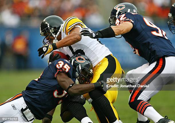Hines Ward of the Pittsburgh Steelers is tackled by Zackary Bowman of the Chicago Bears as teammate Hunter Hillenmeyer closes in on September 20,...