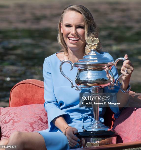 Caroline Wozniacki of Denmark poses with the Daphne Akhurst Memorial Cup on a punt whilst taking a ride on Ornamental Lake in the Royal Botanical...
