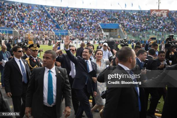 Juan Orlando Hernandez, Honduras's president, center left, and First Lady Ana Garcia Carias, center right, arrive for the presidential inauguration...