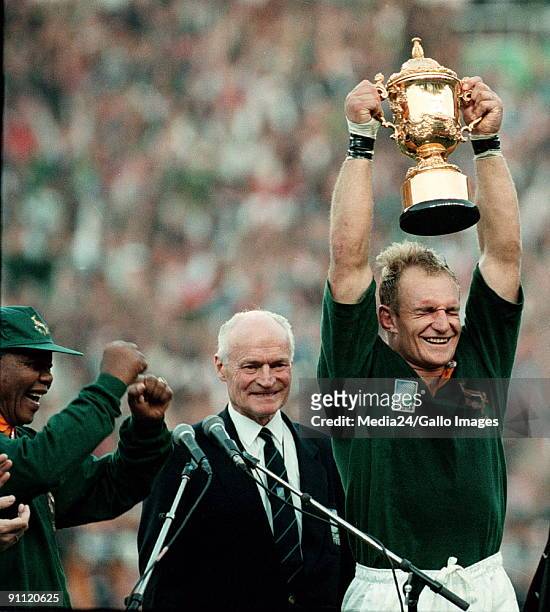 South Africa. Captain of the Springbok team, Francois Pienaar holds the Web Ellis trophy up high after defeating the All Blacks at the World Cup....