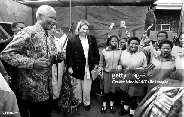 Former South African President Nelson Mandela waves at the Riemvasmaak people. With him is his PA Zelda la Grange.