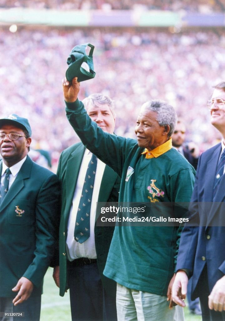 South African president Nelson Mandela, dressed in a No 6 Springbok jersey, celebrates after South Africa beat the All Blacks by 15-12 to win the 1995 Rugby World Cup.