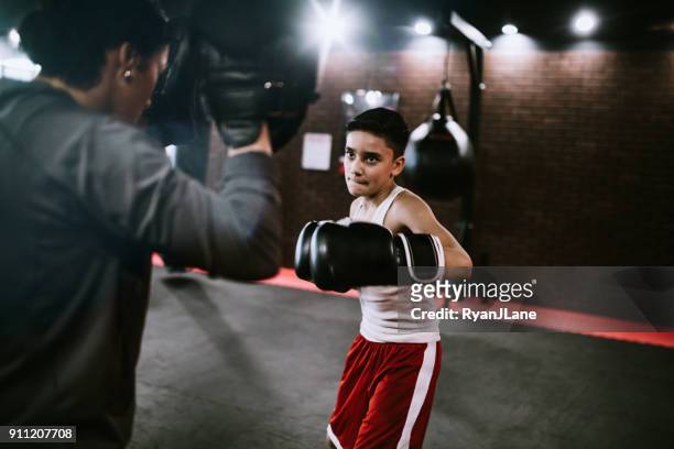 young man in kickboxing training center - boxing training stock pictures, royalty-free photos & images