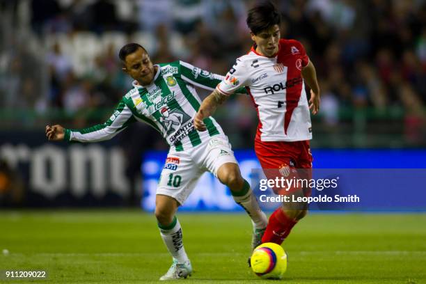 Matias Fernandez of Necaxa figths for the ball with Luis Montes of Leon during the 4th round match between Leon and Necaxa as part of the Torneo...