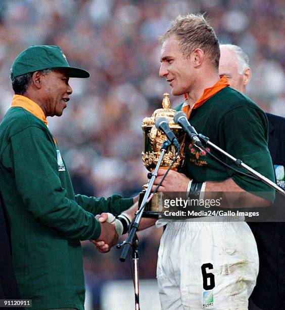 South African president Nelson Mandela, dressed in a No 6 Springbok jersey, congratulates the Springbok captain Francois Pienaar after South Africa...