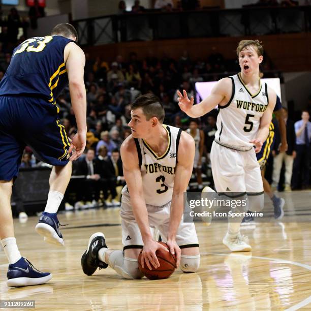 Fletcher Magee guard Wofford College Terriers goes to his knees to recover a loose basketball against the East Tennessee State University...