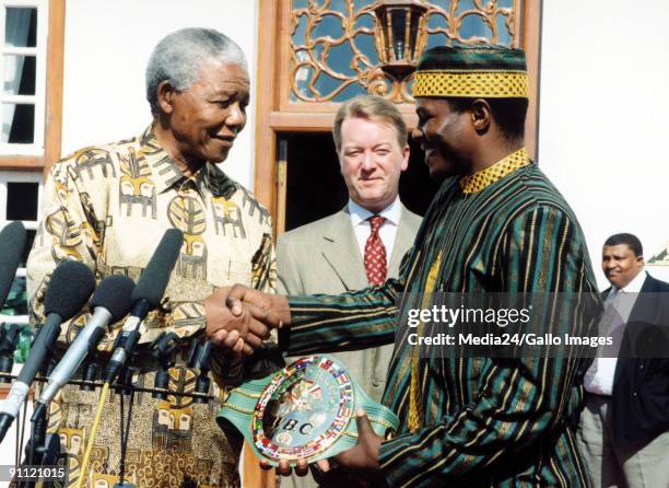 President Nelson Mandela presents Sugarboy Malinga with his WBC super-middleweight championship belt.