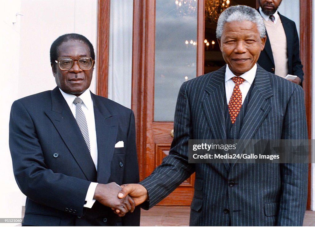 South Africa. Nelson Mandela as President, pictured with Zimbabwean president, Robert Mugabe during a state visit..