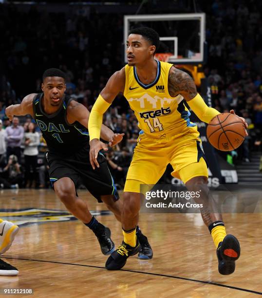 Denver Nuggets guard Gary Harris, right, charges up court against Dallas Mavericks guard Dennis Smith Jr. #1 in the first half at the Pepsi Center...