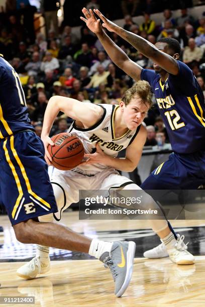 Fletcher Magee guard Wofford College Terriers attempts to drive to the paint against Jalan McCloud guard East Tennessee State University Buccanneers,...