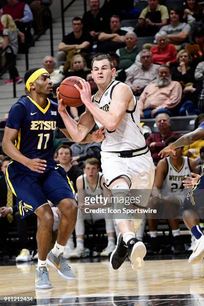 Fletcher Magee guard Wofford College Terriers drives for the basket and two of his game-high 20 points against the East Tennessee State University...