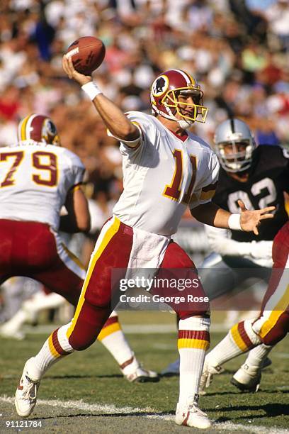 Quarterback Mark Rypien of the Washington Redskins passes the ball during the game against the Los Angeles Raiders at RFK Stadium on October 29, 1989...