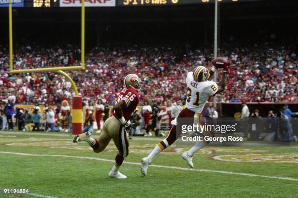 Wide receiver Art Monk of the Washington Redskins catches a 31 yard touchdown pass from Mark Rypien against defensive back Darryl Pollard of the San...