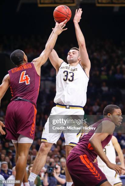 John Mooney of the Notre Dame Fighting Irish shoots the ball against Nickeil Alexander-Walker of the Virginia Tech Hokies at Purcell Pavilion on...