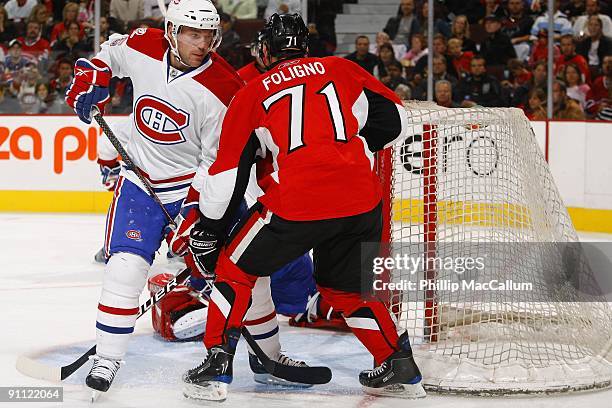 Andre Benoit of the Montreal Canadiens skates to the net against Nick Foligno of the Ottawa Senators battles during a preseason game at Scotiabank...