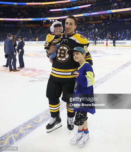 Brad Marchand of the Boston Bruins poses with his kids prior to