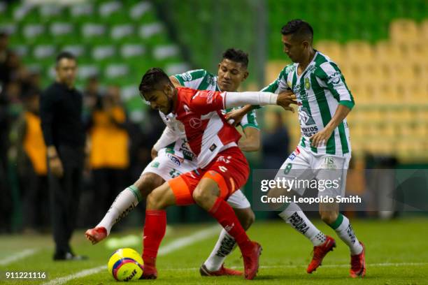 Miguel Ponce of Necaxa figths for the ball with Alexander Mejia and Elias Hernandez of Leon during the 4th round match between Leon and Necaxa as...