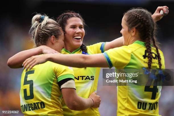 Emma Tonegato, Charlotte Caslick and Dominique Du Toit of Australia celebrate victory at the end of final match against New Zealand during day three...