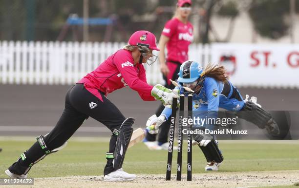 Alyssa Healy of the Sixers runs out Alex Price of the Strikers during the Women's Big Bash League match between the Sydney Sixers and the Adelaide...