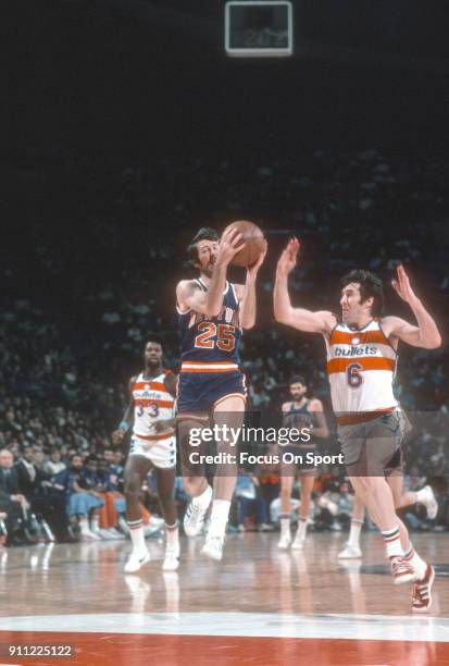 Jim Barnett of the New York Knicks drives on Mike Riordan of the Washington Bullets during an NBA basketball game circa 1976 at the Capital Centre in...