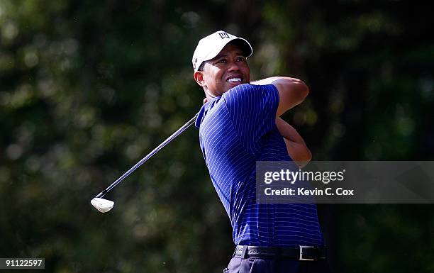 Tiger Woods tees off the 11th tee during the first round of THE TOUR Championship presented by Coca-Cola, the final event of the PGA TOUR Playoffs...