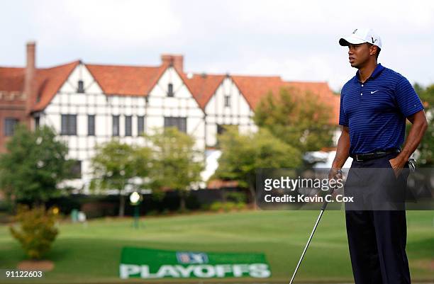 Tiger Woods waits to tee off the seventh hole during the first round of THE TOUR Championship presented by Coca-Cola, the final event of the PGA TOUR...