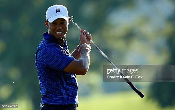 Tiger Woods lines up his par putt on the 18th green during the first round of THE TOUR Championship presented by Coca-Cola, the final event of the...