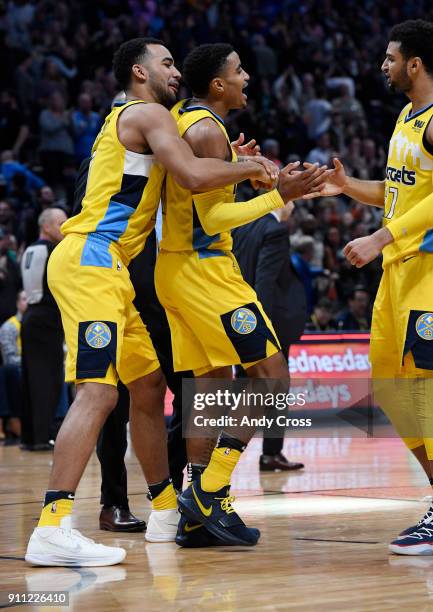 Denver Nuggets forward Trey Lyles, left, guard Gary Harris, center, and Jamal Murray celebrate their victory over the Dallas Mavericks 91-89 at the...