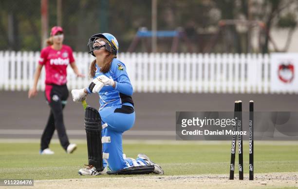 Alex Price of the Strikers reacts after losing her wicket during the Women's Big Bash League match between the Sydney Sixers and the Adelaide...