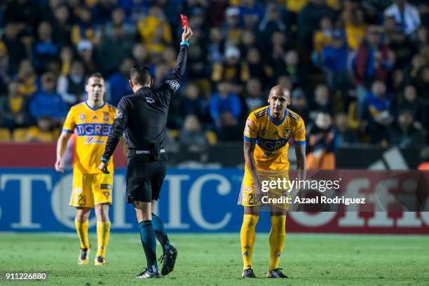 Referee Oscar Mejia gives a red card to Luis Rodriguez of Tigres during the 4th round match between Tigres UANL and Pachuca as part of the Torneo...