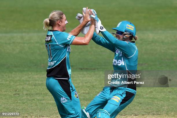 Delissa Kimmince of the Heat celebrates with Beth Mooney after dismissing Stefanie Taylor of the Thunder during the Women's Big Bash League match...