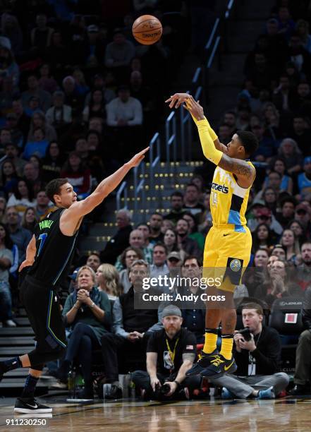 Denver Nuggets guard Gary Harris, right, shoots over Dallas Mavericks forward Dwight Powell in the second half at the Pepsi Center January 27, 2018.