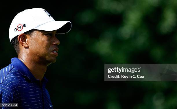 Tiger Woods walks up the 11th fairway during the first round of THE TOUR Championship presented by Coca-Cola, the final event of the PGA TOUR...