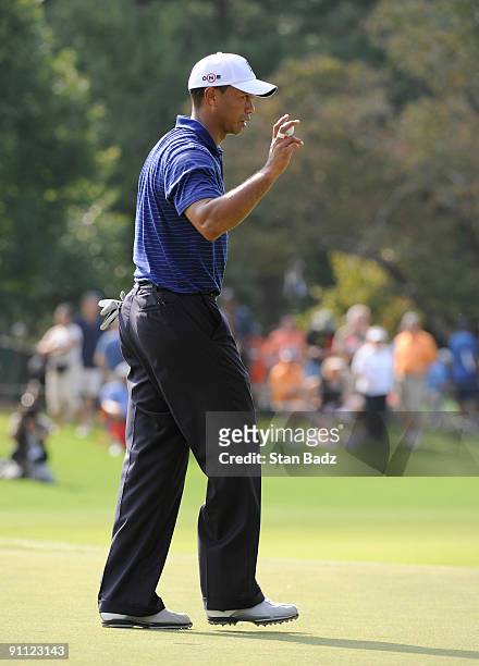 Tiger Woods exits the 10th green during the first round of THE TOUR Championship presented by Coca-Cola, the final event of the PGA TOUR Playoffs for...