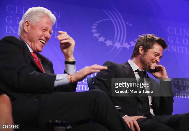 Former President Bill Clinton laughs with actor Brad Pitt while discussing post-Katrina New Orleans at the Clinton Global Initiative September 24,...