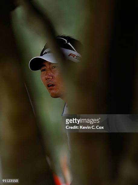 Yang of Korea watches his third shot from the rough on the ninth hole during the first round of THE TOUR Championship presented by Coca-Cola, the...