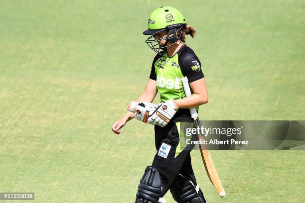 Nicola Carey of the Thunder walks off the field after being caught out by Kirby Short of the Heat during the Women's Big Bash League match between...