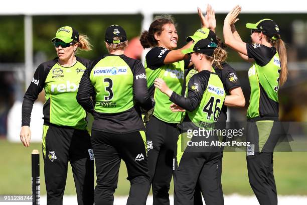 Sydney Thunder players celebrate after Kirby Short of the Heat was caught by Rachel Priest during the Women's Big Bash League match between the...