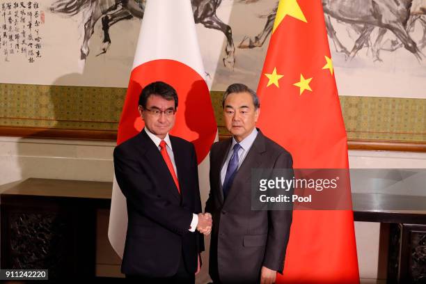 Japanese Foreign Minister Taro Kono, left, and Chinese counterpart Wang Yi pose for a photograph before their meeting at the Diaoyutai State...