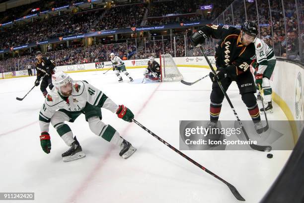 Cleveland Monsters defenceman Cameron Gaunce plays the pick as Iowa Wild center Landon Ferraro defends during the first period of the American Hockey...