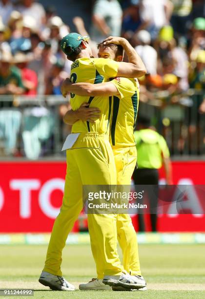 Andrew Tye of Australia celebrates getting the final wicket with team mate Mitchell Marsh during game five of the One Day International match between...
