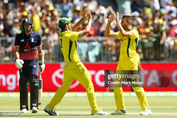 Andrew Tye of Australia celebrates getting the final wicket with team mate Mitchell Marsh during game five of the One Day International match between...