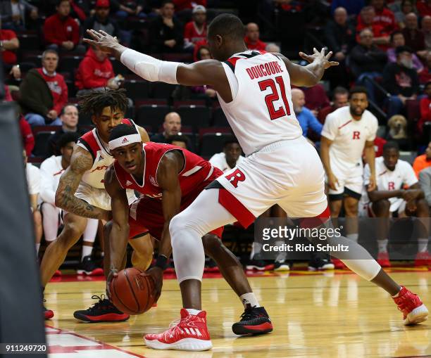 Glynn Watson Jr. #5 of the Nebraska Cornhuskers in action as Corey Sanders and Mamadou Doucoure of the Rutgers Scarlet Knights defends during a game...