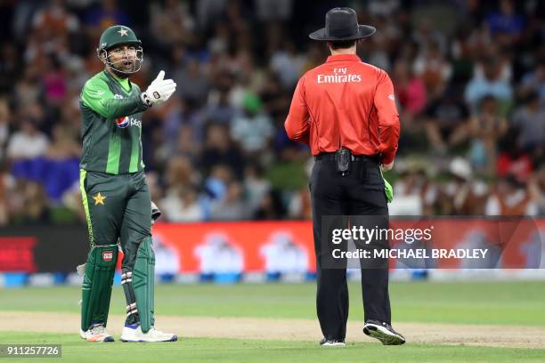 Pakistan's Sarfraz Ahmed talks to the umpire during the third Twenty20 international cricket match between New Zealand and Pakistan at Bay Oval in...